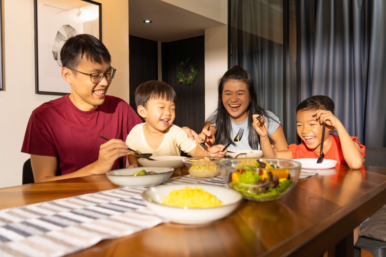 Parents enjoying a meal with their children