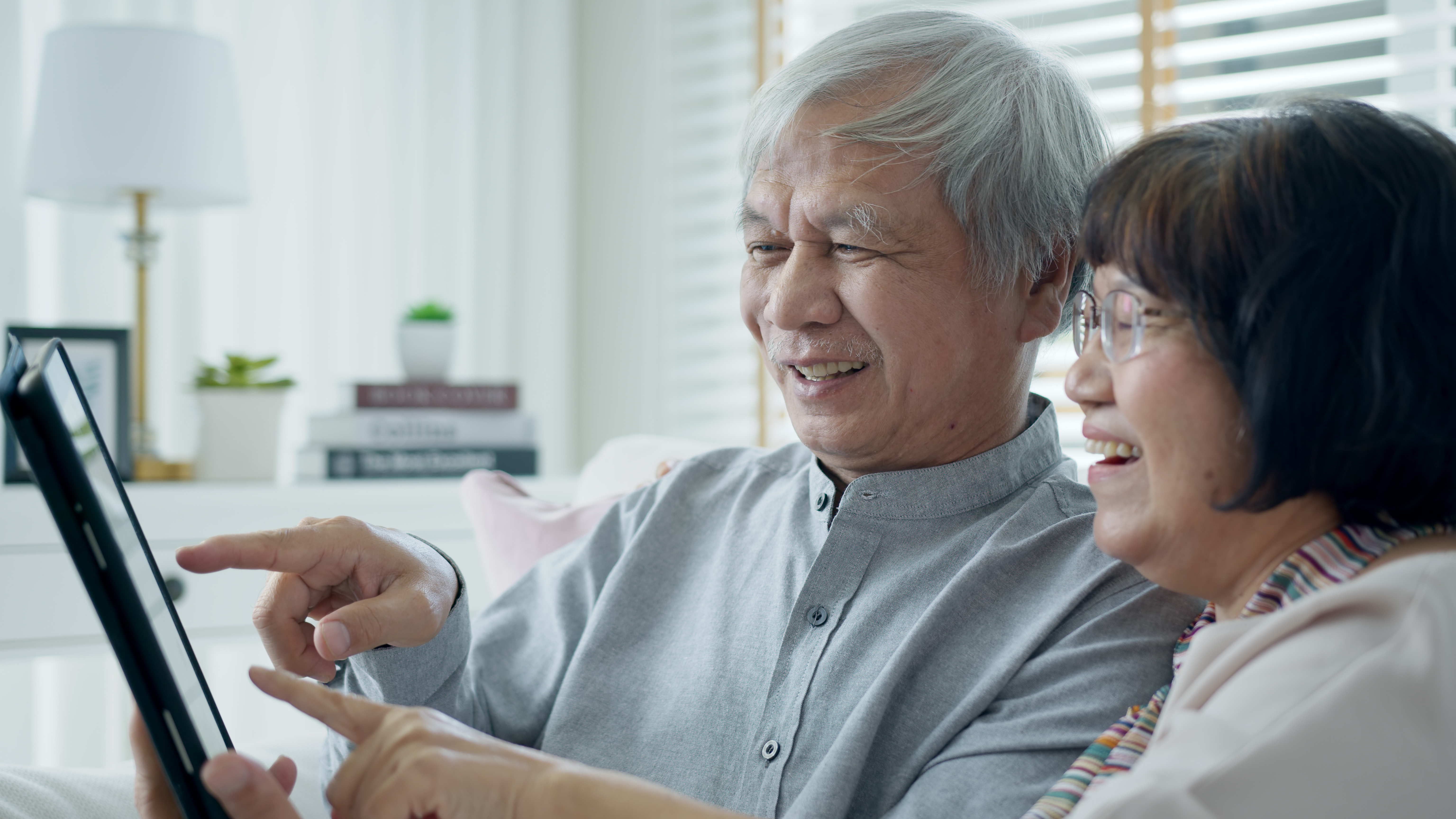 Elderly couple using tablet