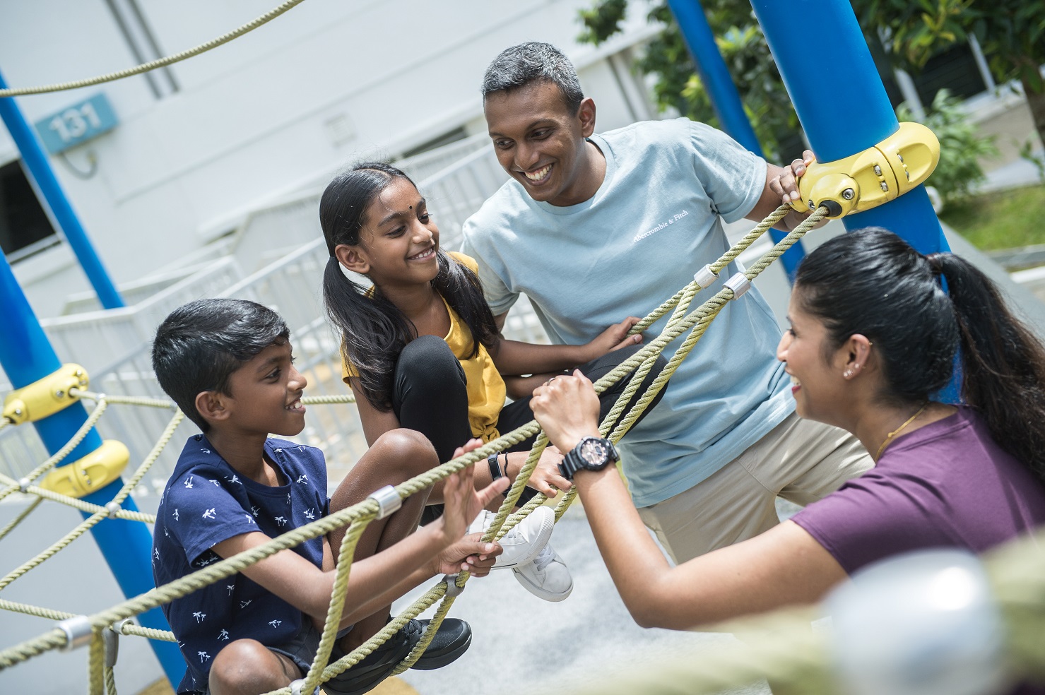 parents spending a day out at the playground with their kids