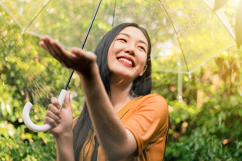 Lady holding an umbrella under the rain