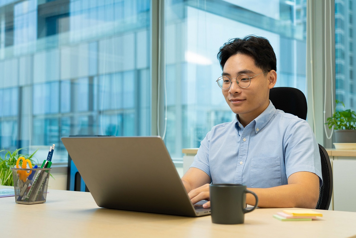 Young man looking at a laptop 