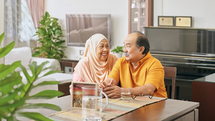 Elderly couple relaxing in their home