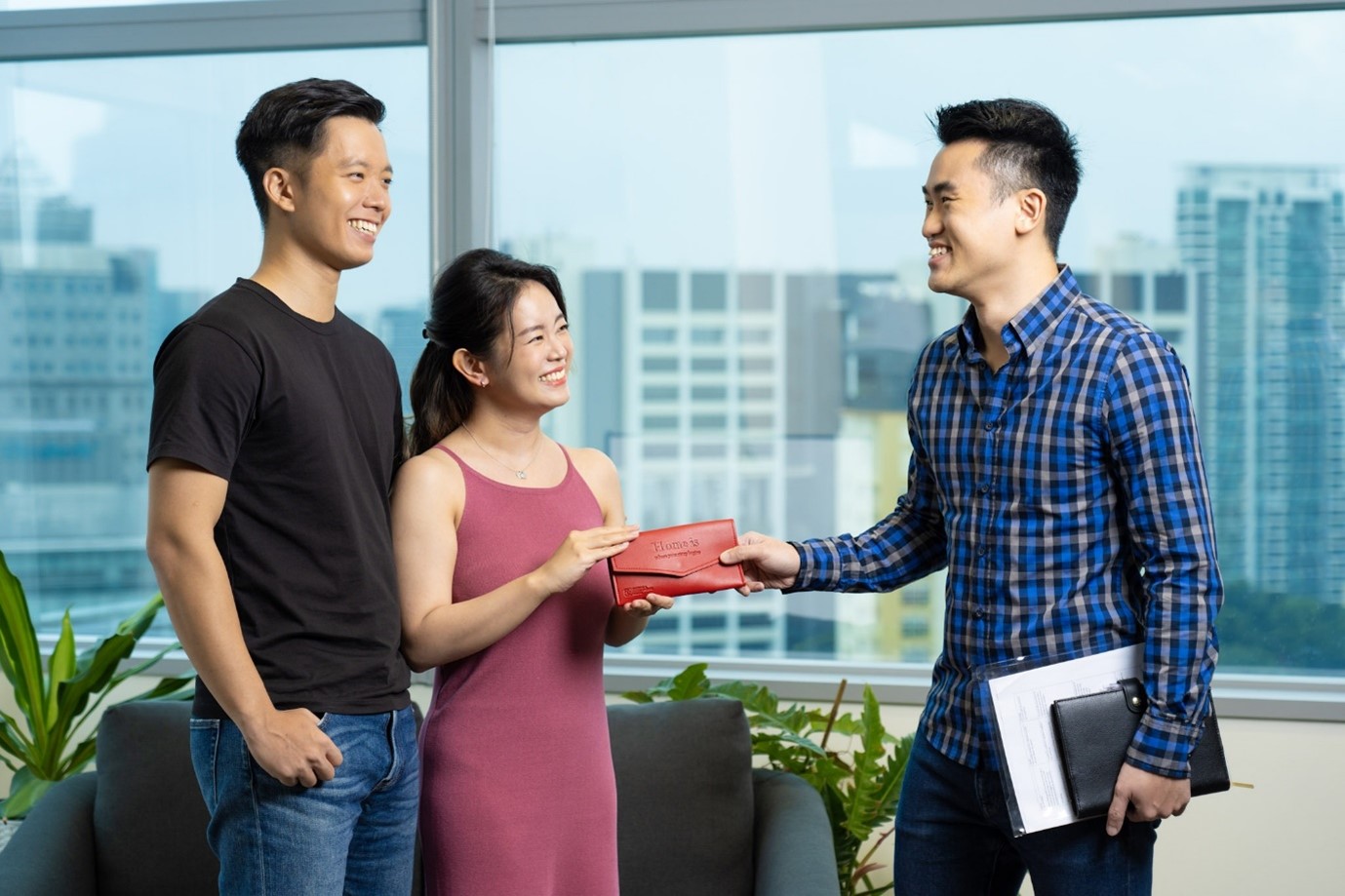 Young couple receiving home keys