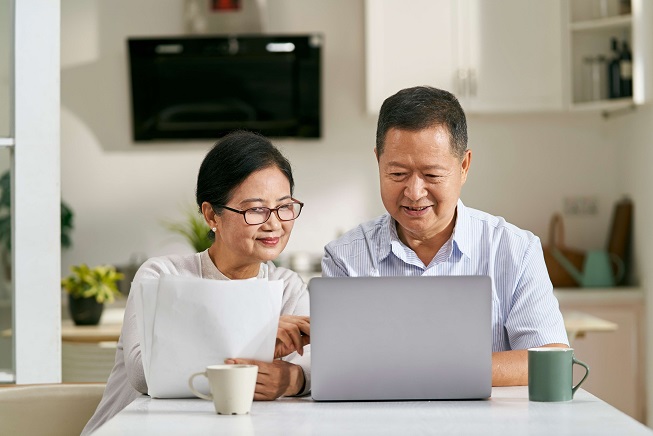 Couple looking at a laptop together