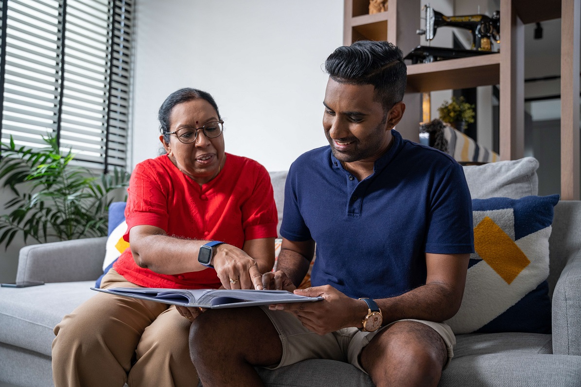 Indian mother and son reviewing documents