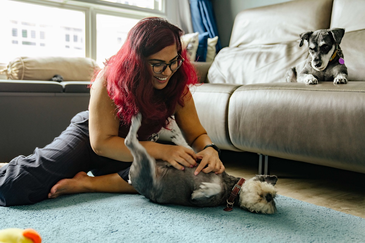 young lady playing with her dog at her home