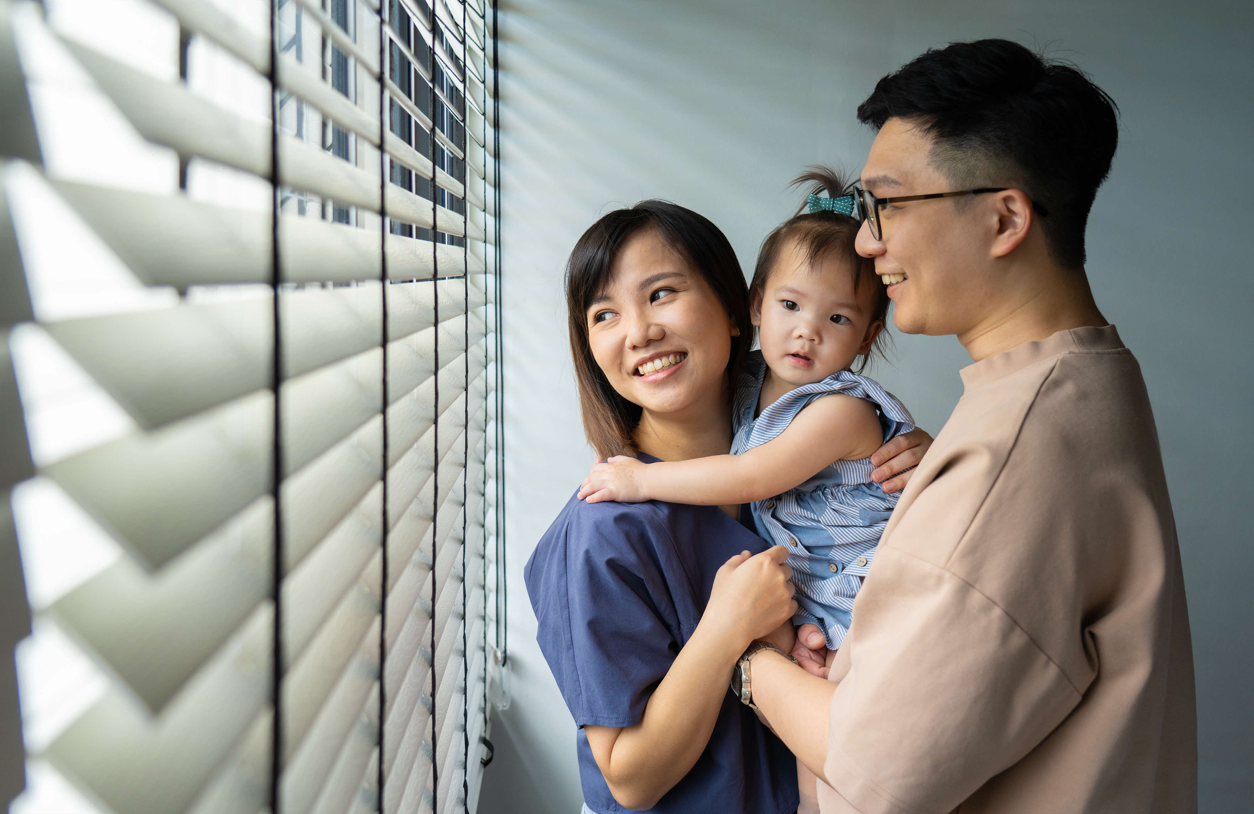 young parents with daughter looking ahead