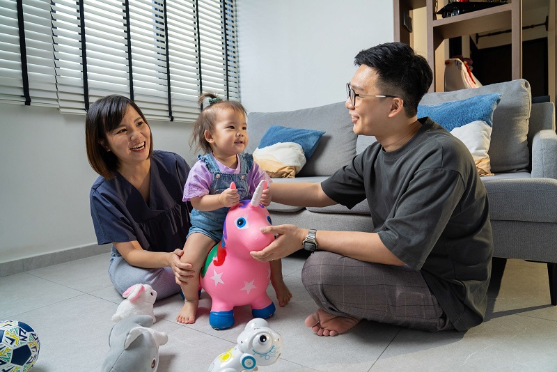 young couple playing with their daughter