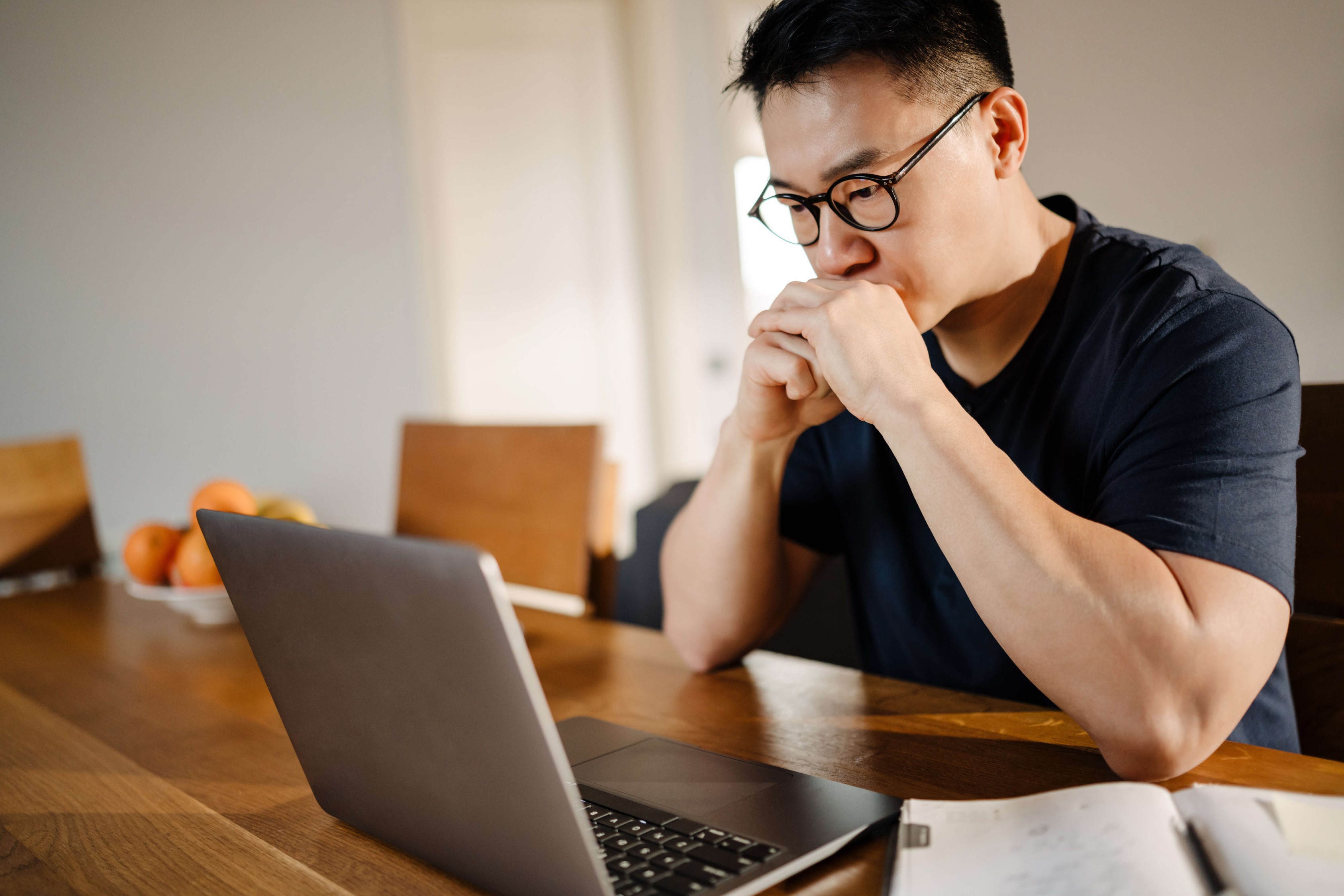 Man learning about scams on his laptop