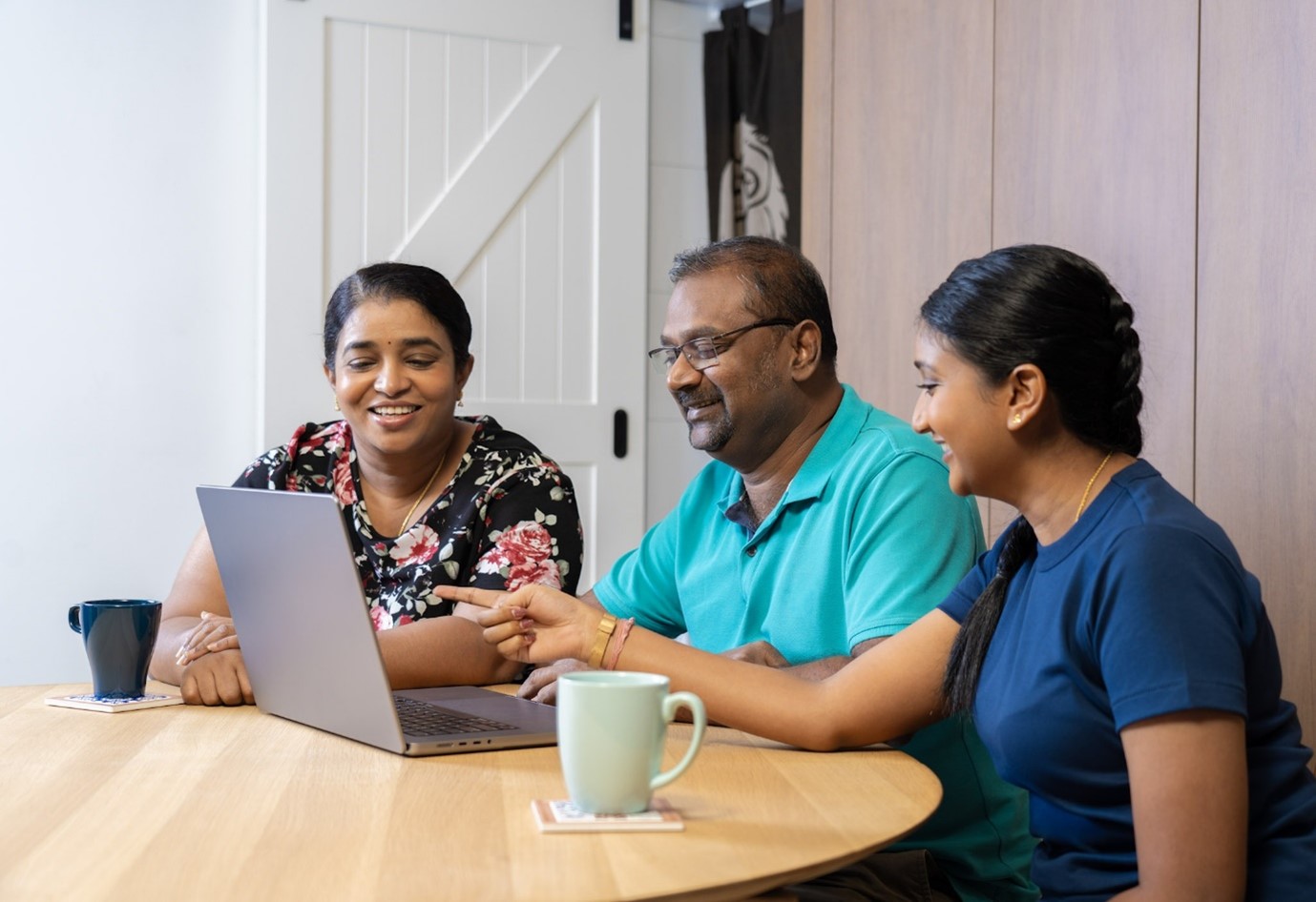 Family looking at a laptop together