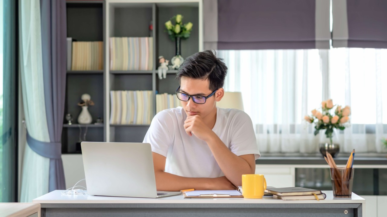 Young man using laptop Young man using laptop to plan his finances