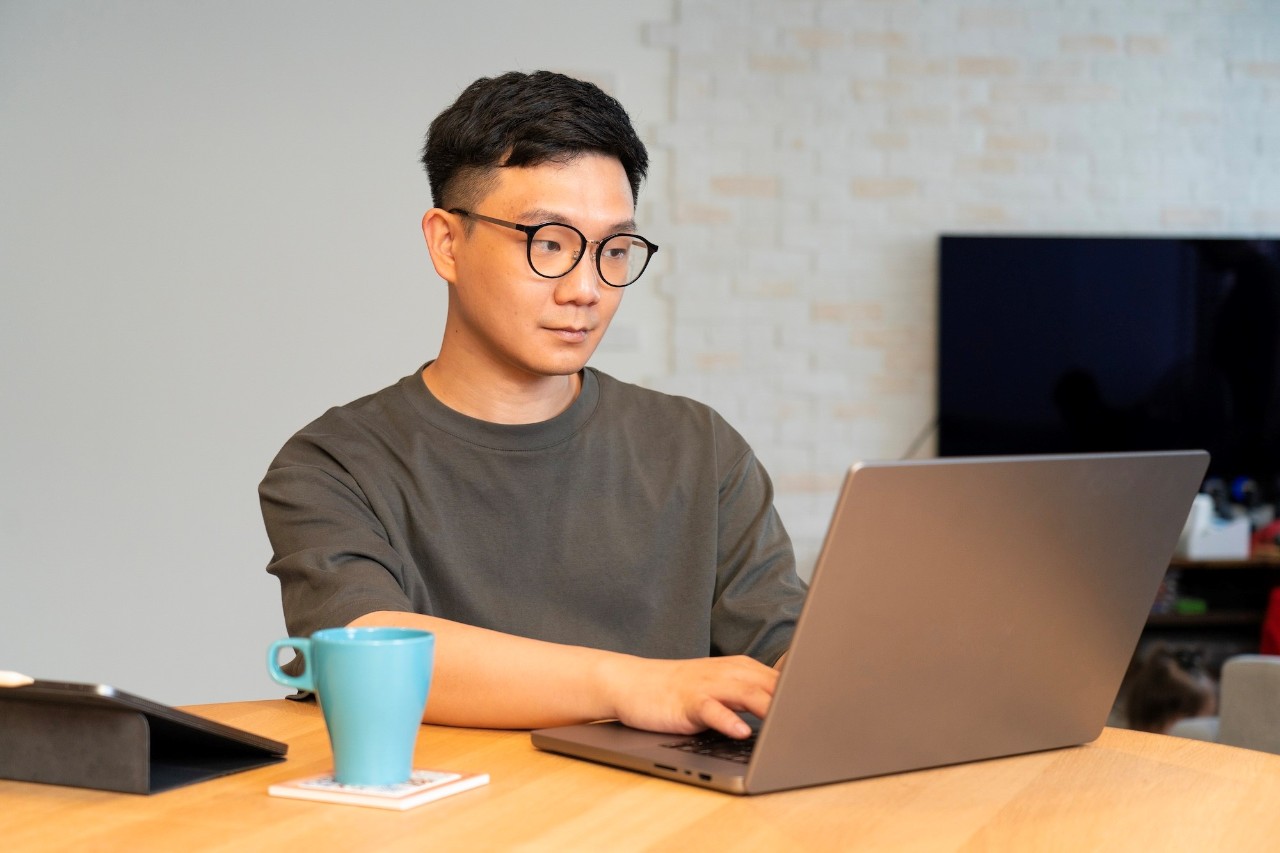 Young adult using laptop